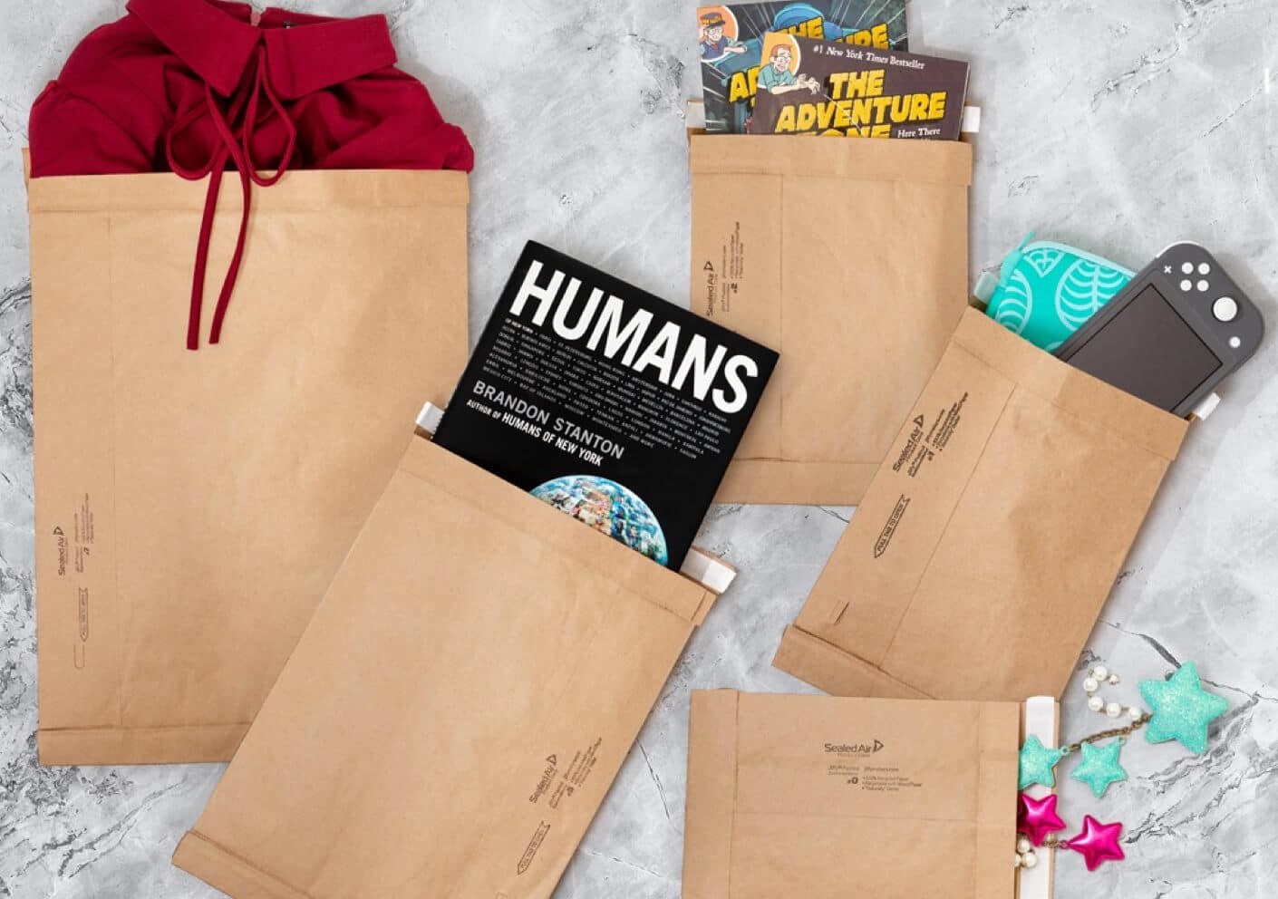 A collection of brown eco-friendly mailers of different sizes with different products sticking out of each of them.